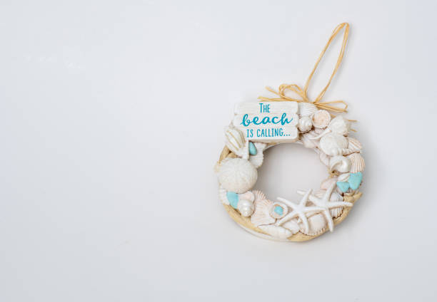 Sandy beach with seashells as a natural textured backdrop for summer vacation and holiday concept.