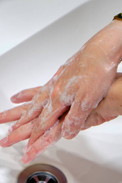 istock Woman use soap and washing hands under the water tap. 1401778675