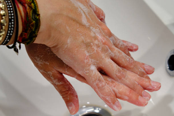 istock Woman washing her hands with soap. 1401778680
