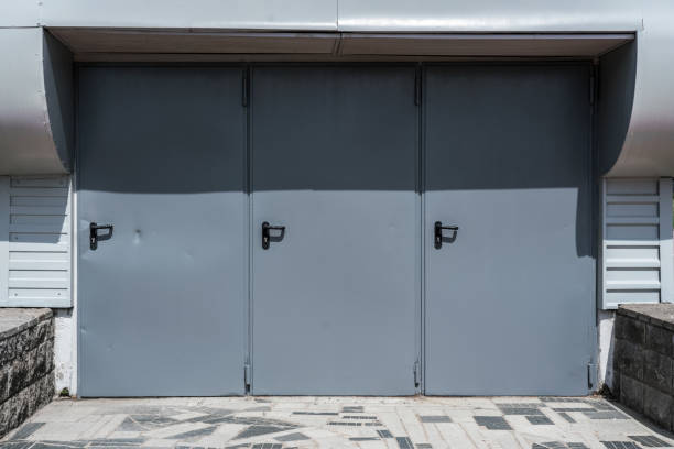 istock Three grey colored doors with black handles is warehouse entrance 1401779029