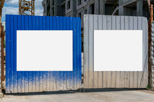 istock Dual blank sign boards mounted on gate at construction site. 1401779030