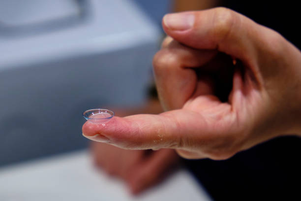 istock A woman's hands with a contact lens. 1401779154