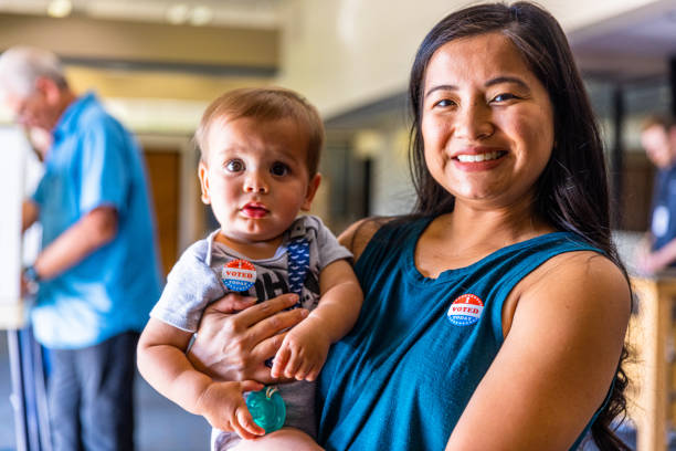 Filipino Woman and her baby boy after voting in an American Election stock photo