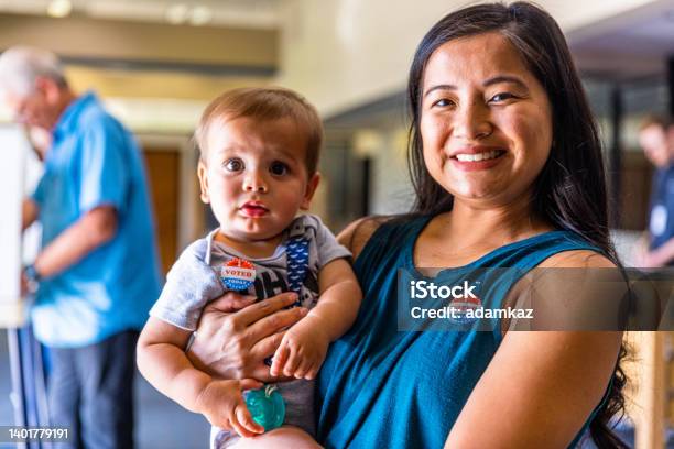 Filipino Woman And Her Baby Boy After Voting In An American Election Stock Photo - Download Image Now