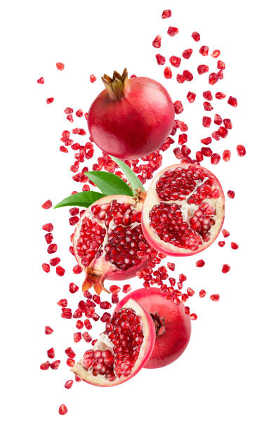 istock falling pomegranates with leaves isolated on a white background with clipping path 1401779859