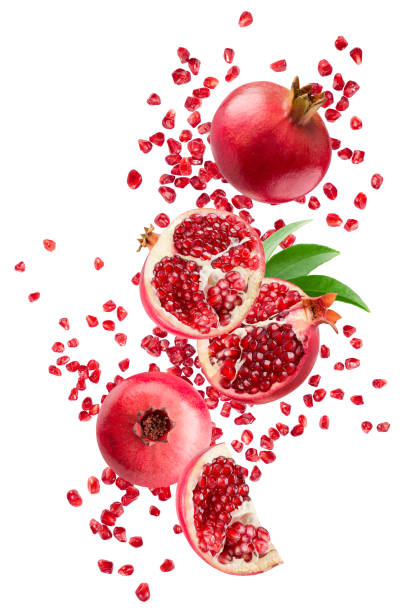 istock falling pomegranates with leaves isolated on a white background with clipping path 1401779935