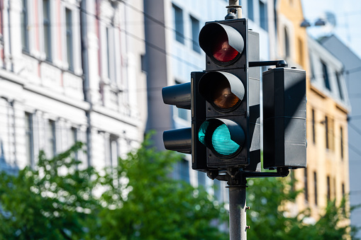 traffic semaphore with green light on the background of defocused urban street, closeup