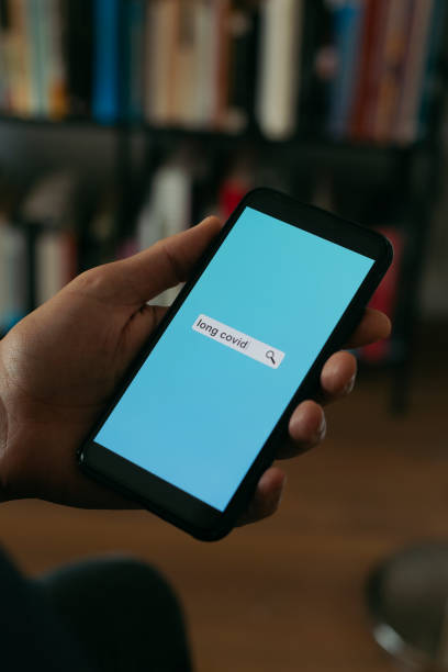 istock searches the text long covid in his smartphone 1401783169