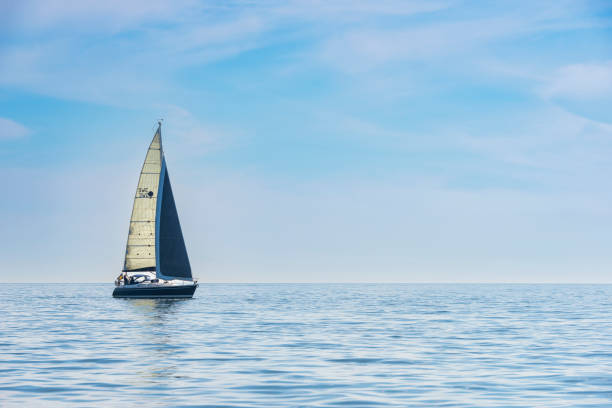 sailing in calm sea - sea water single object sailboat imagens e fotografias de stock