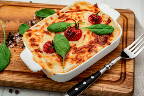 istock Baking dish with tasty vegetable lasagna on wooden background 1401787400
