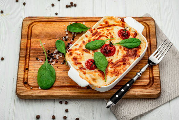 istock Baking dish with tasty vegetable lasagna on wooden background 1401787406