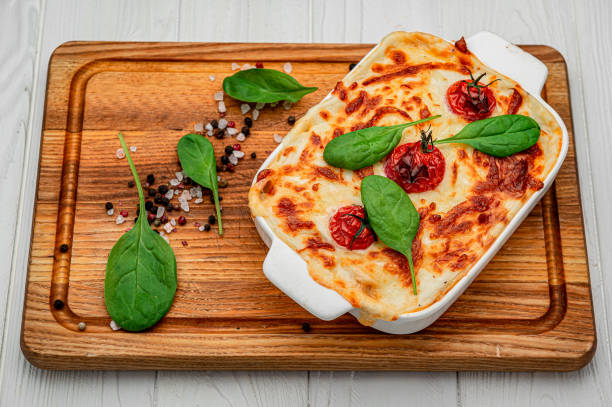 istock Baking dish with tasty vegetable lasagna on wooden background 1401787408