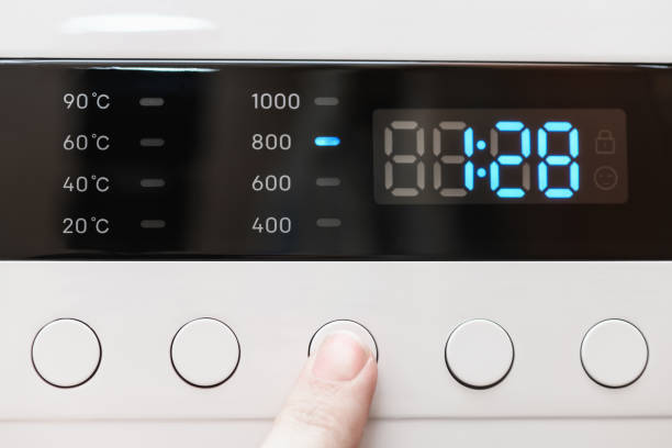 istock Washing machine display close up ,time remaining one hour 28 minutes during washing process. Finger selects wash mode. Abstract laundry programming backdrop 1401788447