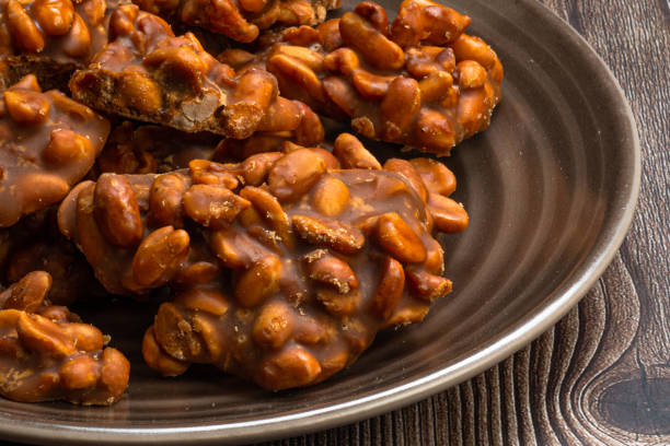 istock Peanut candy served in a brown silver on wooden background. 1401790289