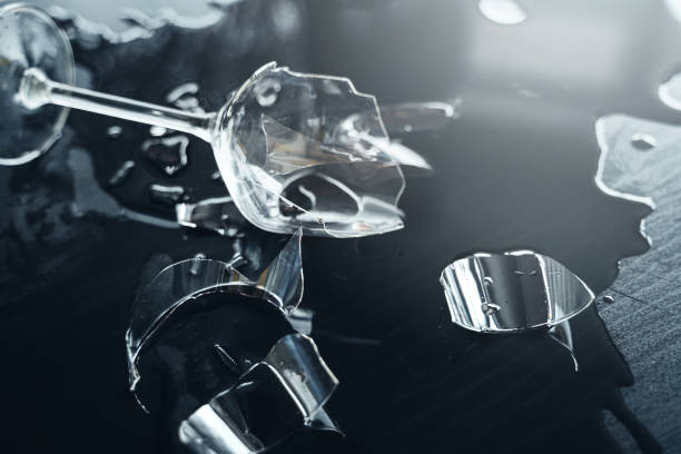 istock Broken wine glass with a lot of sharp shards on the table 1401791089