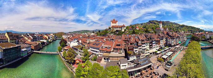 Splendid aerial panorama of Thun old town with medieval castle and Alps mountains on background. Incredible beautiful Switzerland.