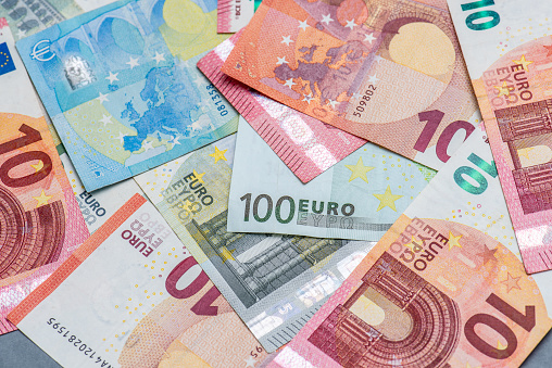 Group of euros bills and gavel.