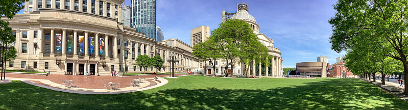 Boston, Massachusetts, USA - May 23, 2022: View of people walking around The Christian Science Center, a popular tourist attraction, which refers to it as Christian Science Plaza. Massachusetts is the headquarters of the Christian Science Church.