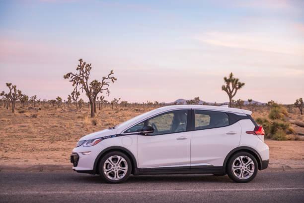 Chevy Bolt Electric Vehicle Parked on Scenic Road in Joshua Tree National Park USA at Dusk stock photo