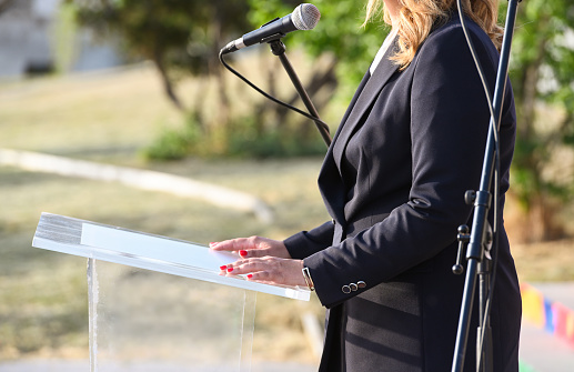 Unrecognizable mid adult female politician or businesswoman giving a public speech, Nikon Z7