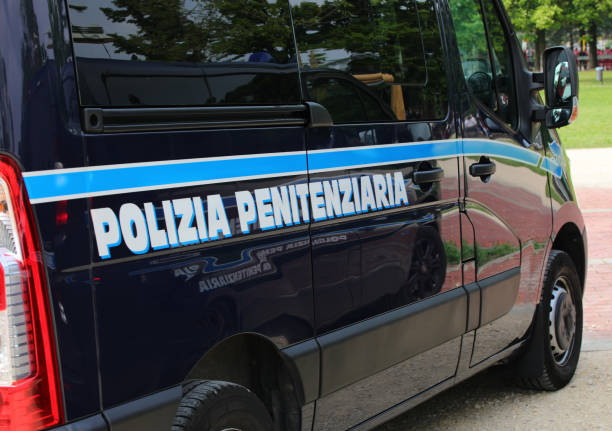 Van with text POLIZIA PENITENZIARIA that means prison officers in italian language Vicenza, VI, Italy - June 2, 2022: Blue Van with text POLIZIA PENITENZIARIA that means prison officers in italian language prison guard stock pictures, royalty-free photos & images