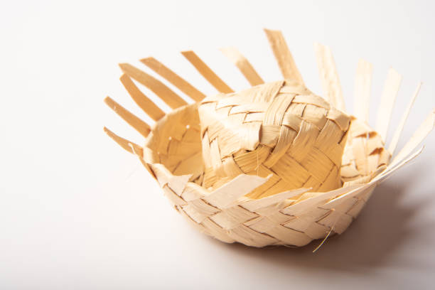 Mini straw hat used in Junina party decoration in Brazil, placed on white background, selective focus.