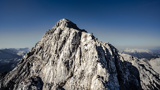 Mountaineer climbing on top of Watzmann middle peak in the german alps.