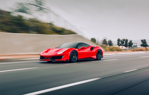Seattle, WA, USA\n5/22/2022\nFerrari 488 Pista in red driving on the highway with white lines
