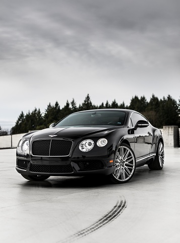 Seattle, WA, USA
6/7/2022
Bentley Continental GT parked sideways with grey skies overhead in black