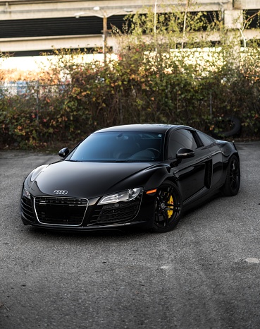 Seattle, WA, USA\n6/1/2022\nBlack Audi R8 parked on asphalt with bushes in the background