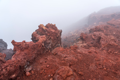 Red rocks of recent eruption of volcano Eldfell, on island of Heimaey in Vestmannaeyjar islands