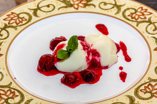 istock Panakota with cherry jelly and mint leaves on a white background 1401802881