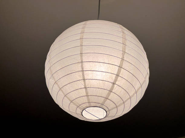 istock A simple ceiling lamp made of white paper. 1401803467