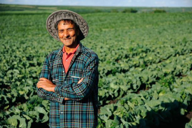 istock Front view. Thai Asian farmer plaid shirt with folded hands. 1401805621