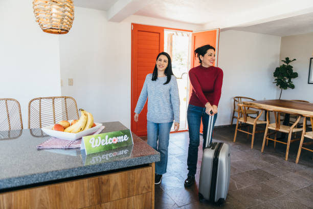 istock Lesbian couple arrive at vacation rental 1401806648