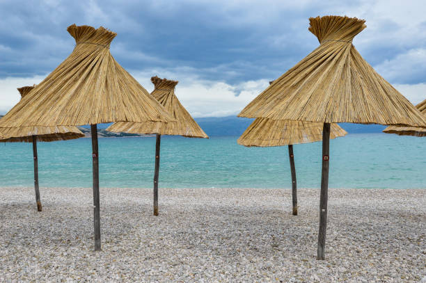 istock Bamboo parasols at empty Vela plaza beach. 1401807231