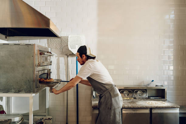 istock Portrait of a kitchen chef working in a pizza place 1401807604
