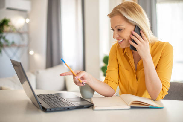 istock Mid adult woman working from home 1401808518