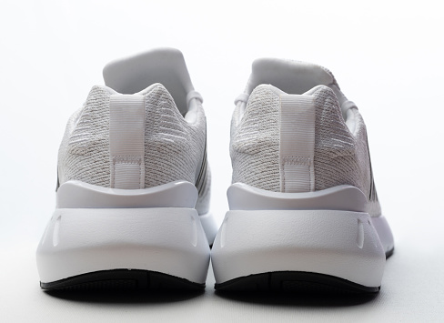 Back view of sport white shoes isolated on studio background