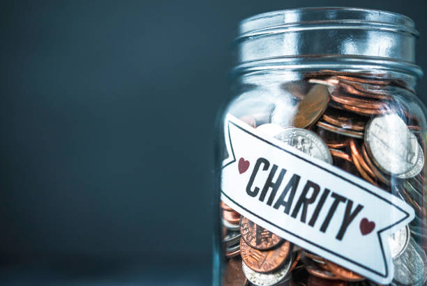 istock Charity donation money jar background with space for text 1401815243