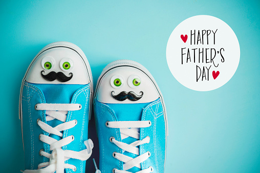 Father's Day Background with Canvas Shoes with Face and Father's Day Message