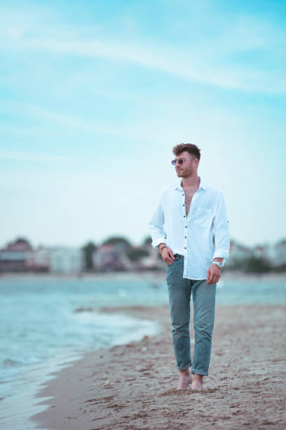 istock young handsome man on the beach in summer season 1401815297