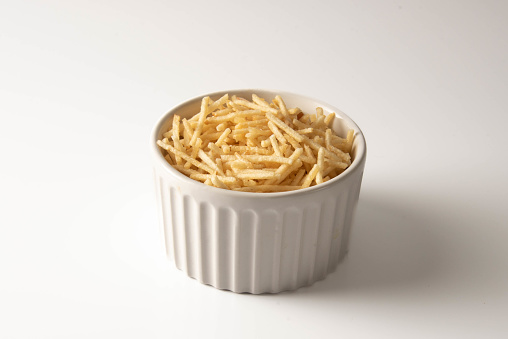 Potato straw or potato straw in a bowl isolated over white background.