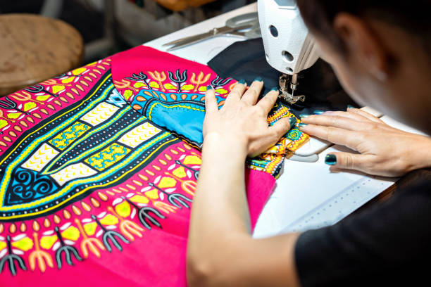 istock Woman seamstress in the workshop using the sewing machine. 1401817602