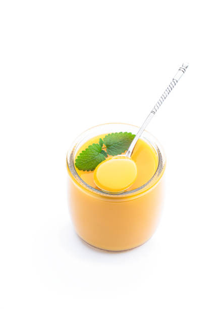 istock Yellow and orange fruit puree in glass jar isolated on white 1401818414
