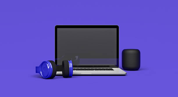 3D illustration mockup of a laptop computer on a trendy purple minimal background with headphones and wireless speaker with clipping path for easy screen replacement stock photo