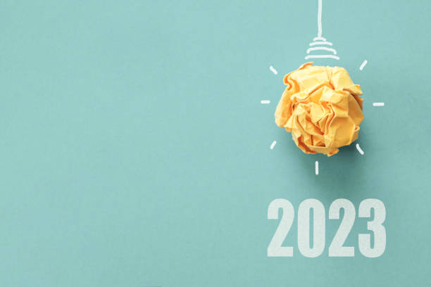 2023 Yellow paper light bulb on blue background, innovative business vision and resolution concept 2023 Yellow paper light bulb on blue background, innovative business vision and resolution concept changing focus stock pictures, royalty-free photos & images