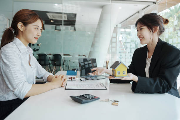 istock Guarantee, mortgage, agreement, contract, signed, real estate agent pointing to documents for customers to read the agreement before signing important documents 1401822280