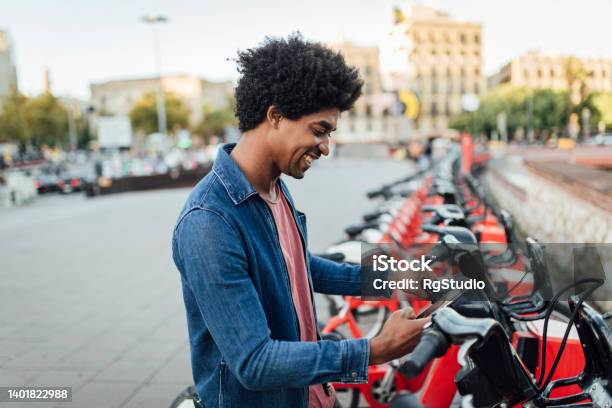 Portrait Of A Young Afro Tourist Renting An Ebike Stock Photo - Download Image Now