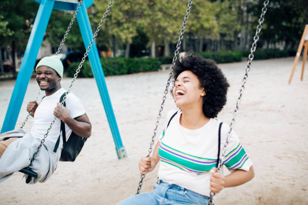 istock Happy couple having fun swinging on a playground. 1401823138
